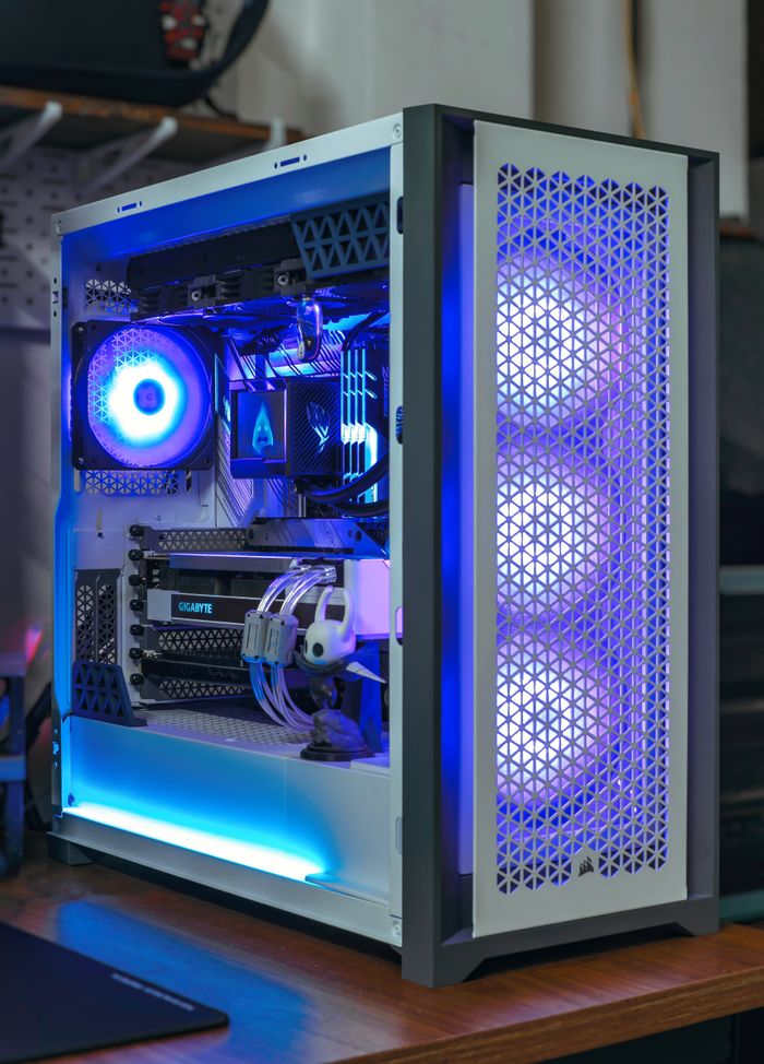 Services A sleek desktop PC with vibrant blue RGB lighting showcasing modern computer technology.