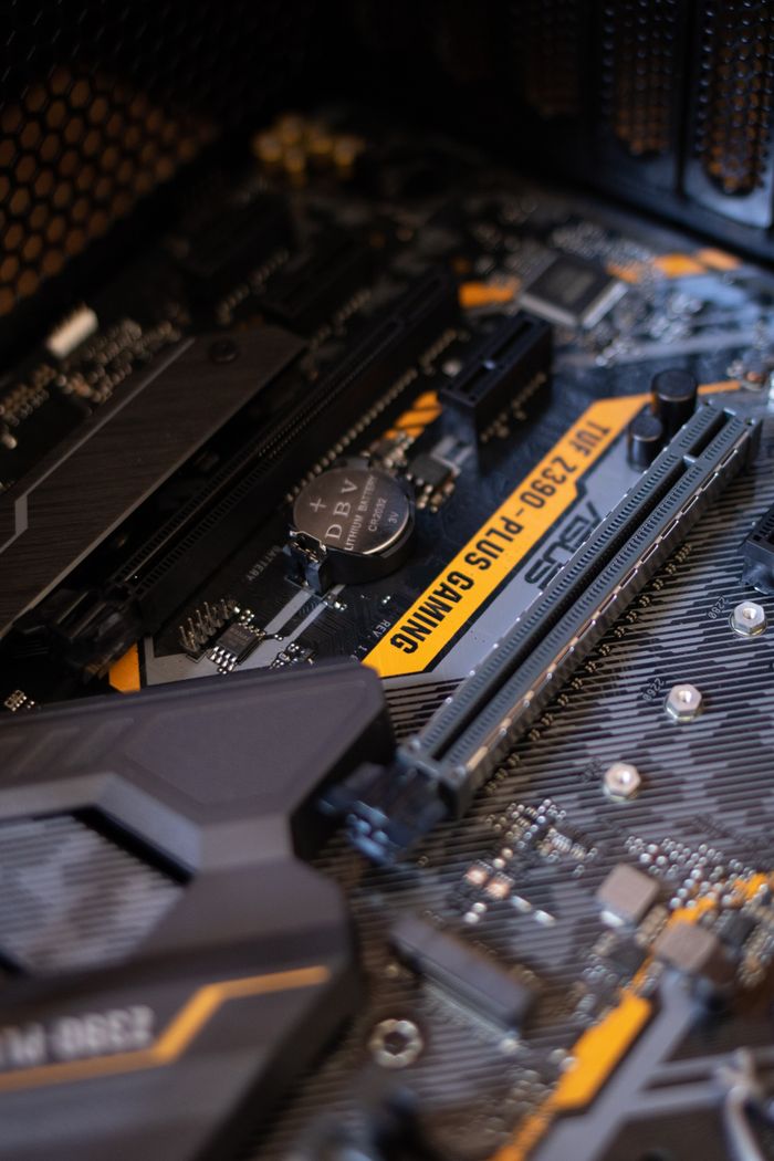 Services Detailed view of a gaming motherboard with capacitors and microchips.
