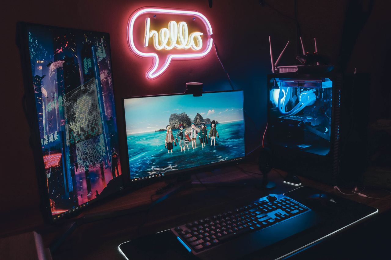 Crafting Captivating Headlines: Your awesome post title goes here A sleek gaming setup with neon 'hello' sign, dual monitors, and illuminated PC for a futuristic vibe.